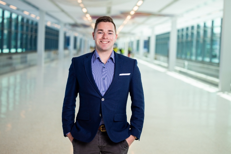 Henry Meeds smiles while standing inside the pedestrian bridge at the KCI terminal